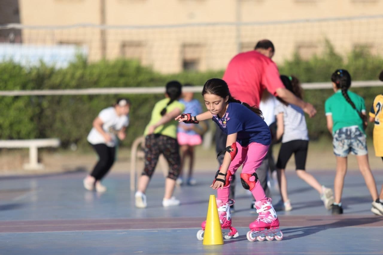 A young skater learning around cones